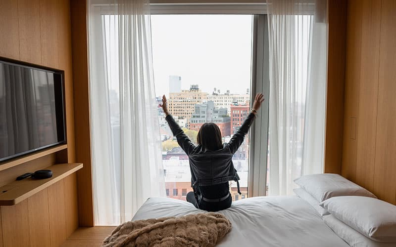 woman stretching on bed